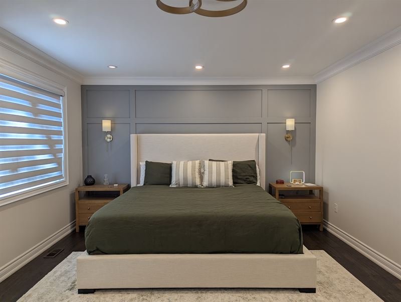 Full-height shaker panel accent wall in a gray bedroom, flat strips in an even grid from floor to ceiling