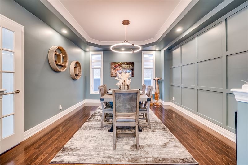 Full-height shaker panel wall in a teal dining room, flat strips in a grid with the wall painted the same colour